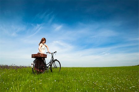 simsearch:400-04201795,k - Happy young woman on a green meadow with a vintage bicycle Fotografie stock - Microstock e Abbonamento, Codice: 400-04198837