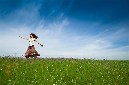 Young woman dancing on a beautiful green meadow Stock Photo - Budget Royalty-Free & Subscription, Code: 400-04198845