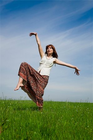 Young woman making dancing poses on a beautiful green meadow Stock Photo - Budget Royalty-Free & Subscription, Code: 400-04198847