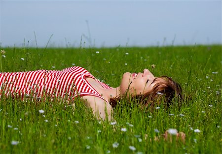 Young woman relaxing on a beautiful green meadow Stock Photo - Budget Royalty-Free & Subscription, Code: 400-04198849