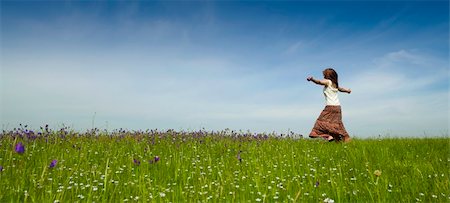 Young woman dancing on a beautiful green meadow Stock Photo - Budget Royalty-Free & Subscription, Code: 400-04198843