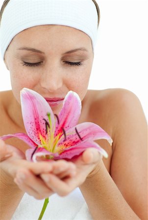 simsearch:400-05663148,k - Beautiful woman smelling a flower against a white background Photographie de stock - Aubaine LD & Abonnement, Code: 400-04198886