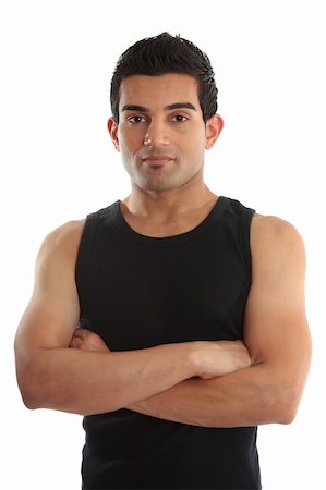 A personal trainer, fitness instructor, gymnast, tradesman or builder wearing a black tank top with arms crossed.  White background. Stock Photo - Budget Royalty-Free & Subscription, Code: 400-04199025