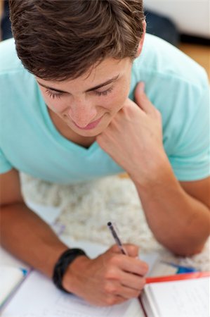 Portrait of a teen guy studying on the floor with his friends Photographie de stock - Aubaine LD & Abonnement, Code: 400-04199084