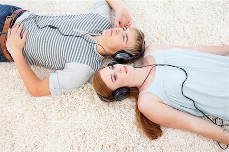 High angle of couple of teenagers listening to music  on th floor Stock Photo - Budget Royalty-Free & Subscription, Code: 400-04199098