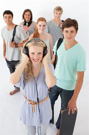 Happy teenagers smiling at the camera agaisnt white background Stock Photo - Budget Royalty-Free & Subscription, Code: 400-04199197
