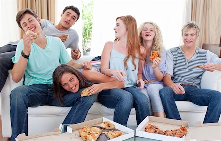 friends and eat and pizza - Six teenagers eating pizza in the living-room on the sofa Stock Photo - Budget Royalty-Free & Subscription, Code: 400-04199219