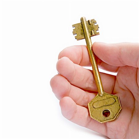 simsearch:400-04980137,k - Golden Key In A Hand Against White Background Stock Photo - Budget Royalty-Free & Subscription, Code: 400-04199413