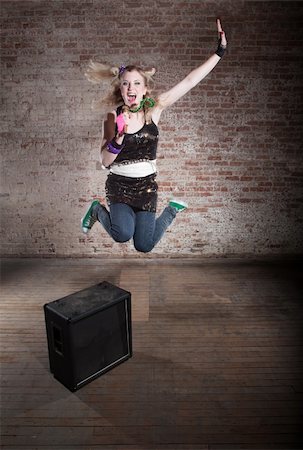 simsearch:400-04655366,k - Young punk rocker jumps from a speaker in front of a brick background Stock Photo - Budget Royalty-Free & Subscription, Code: 400-04199644