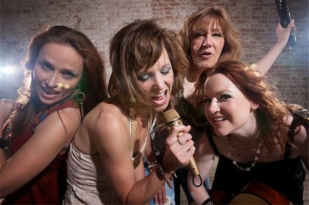 All-girl band performing in stylish clothing at a warehouse Stock Photo - Budget Royalty-Free & Subscription, Code: 400-04199643