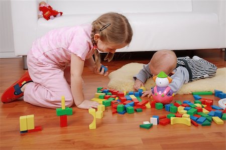 Adorable kids playing together with blocks Stock Photo - Budget Royalty-Free & Subscription, Code: 400-04199908