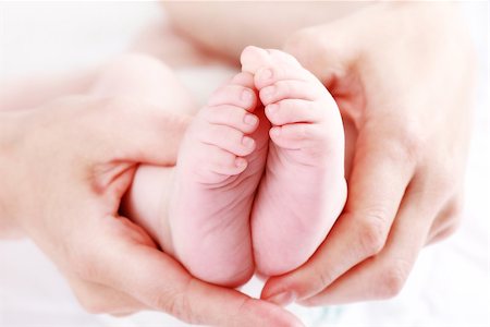 Detail of newborn's feet in mother's hands - shallow DOF Stock Photo - Budget Royalty-Free & Subscription, Code: 400-04199923