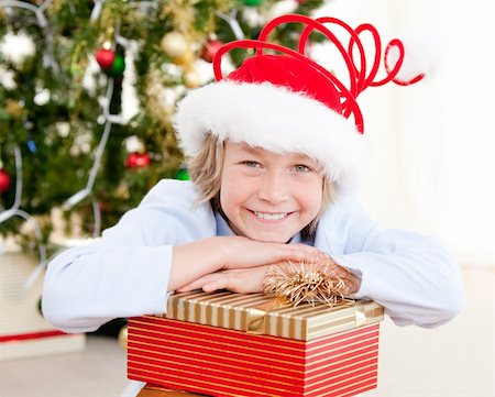 simsearch:400-07088886,k - Smiling child opening his present at christmas time Stock Photo - Budget Royalty-Free & Subscription, Code: 400-04190088