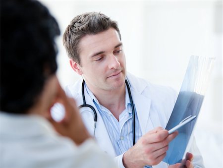 doctor showing results to patient - Professional doctor showing the results to his patient  in the hospital Stock Photo - Budget Royalty-Free & Subscription, Code: 400-04190166