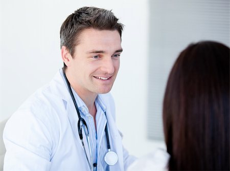 Smiling doctor talking with his patient  in the hospital Stock Photo - Budget Royalty-Free & Subscription, Code: 400-04190167