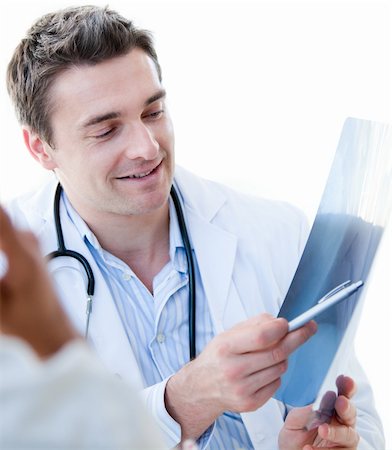 doctor showing results to patient - Portrait of a charming male doctor showing the results to his patient  in the hospital Stock Photo - Budget Royalty-Free & Subscription, Code: 400-04190170