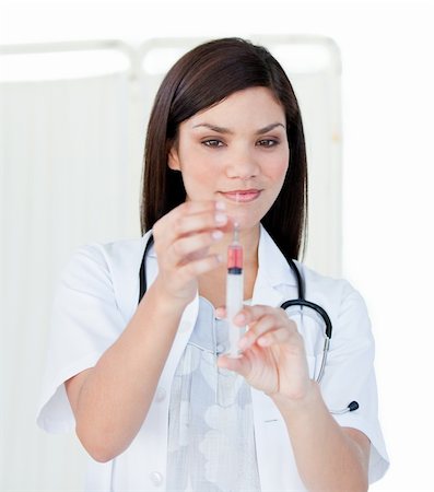 simsearch:400-04513453,k - Portrait of a cute female doctor preparing a syringe in a hospital Stock Photo - Budget Royalty-Free & Subscription, Code: 400-04190186