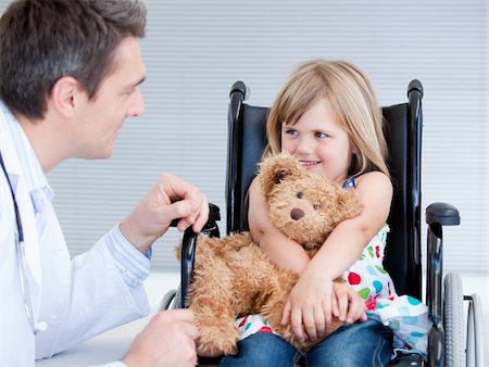 simsearch:400-05147195,k - Smiling little girl sitting on the wheelchair lokking at the doctor in the hospital Stock Photo - Budget Royalty-Free & Subscription, Code: 400-04190190