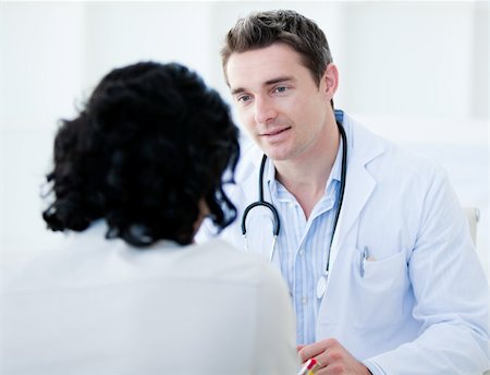 Handsome doctor talking with his patient for the annual check-up in the hospital Stock Photo - Budget Royalty-Free & Subscription, Code: 400-04190193