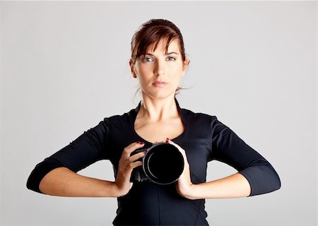 photographer taking picture of model - Portrait of a beautiful and attractive young woman holding a camera Stock Photo - Budget Royalty-Free & Subscription, Code: 400-04190419