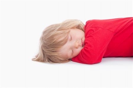 boy with long blond hair lying down sleeping - isolated on white Stock Photo - Budget Royalty-Free & Subscription, Code: 400-04190521