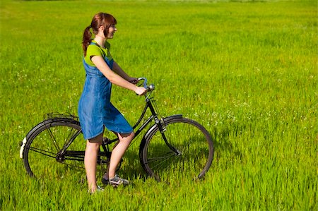 simsearch:400-04201795,k - Happy young woman with a vintage bicycle on a green meadow Stock Photo - Budget Royalty-Free & Subscription, Code: 400-04190671