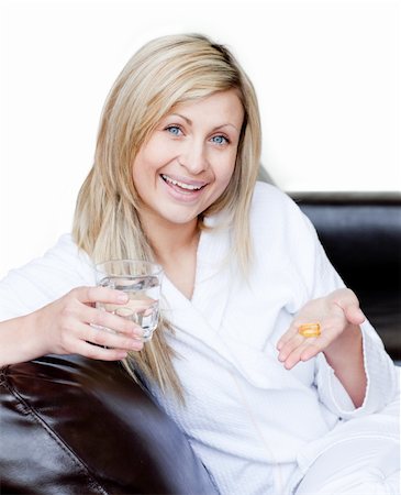 Happy woman holding medicine against a white background Fotografie stock - Microstock e Abbonamento, Codice: 400-04190850