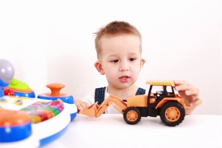 Portrait of lovely boy playing with toys with copy space Stock Photo - Budget Royalty-Free & Subscription, Code: 400-04191639