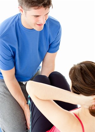 sit ups personal trainer - Brunette woman doing sit-ups assited by her personal trainer in a health club Stock Photo - Budget Royalty-Free & Subscription, Code: 400-04191688