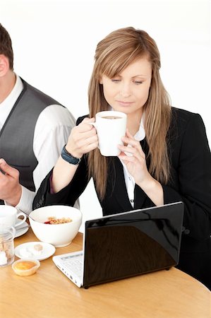 picture of jam on toast and tea - Serious businesswoman using a laptop while having breakfast at home Stock Photo - Budget Royalty-Free & Subscription, Code: 400-04191717