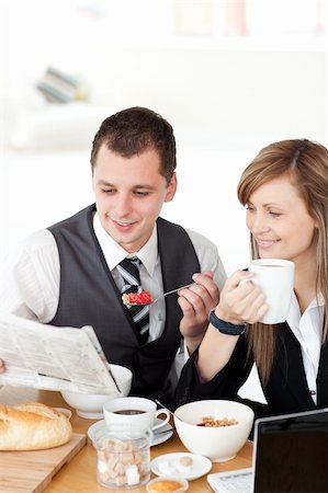 picture of jam on toast and tea - Smiling couple of business people reading a newspaper while having breakfast at home Stock Photo - Budget Royalty-Free & Subscription, Code: 400-04191718