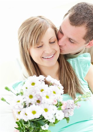 simsearch:400-06415374,k - Loving man giving a bunch of flowers to his girlfriend against a white background Stock Photo - Budget Royalty-Free & Subscription, Code: 400-04191744