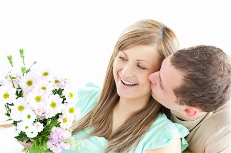 simsearch:400-06415374,k - Enamored man giving a bouquet to his girlfriend against a white background Stock Photo - Budget Royalty-Free & Subscription, Code: 400-04191741