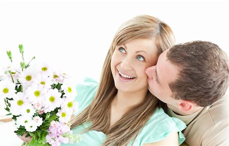 simsearch:400-06415374,k - Caring man giving a bouquet to his girlfriend against a white background Stock Photo - Budget Royalty-Free & Subscription, Code: 400-04191742