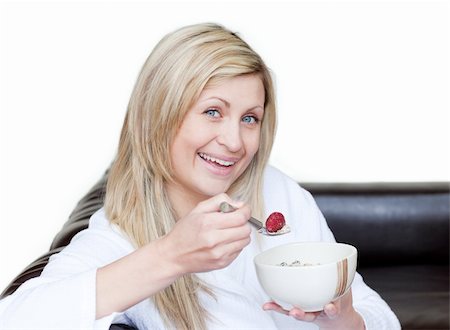 simsearch:400-04708507,k - Cheerful woman having a breakfast against a white background Stock Photo - Budget Royalty-Free & Subscription, Code: 400-04191785