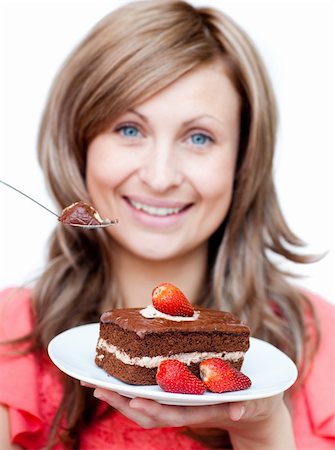 simsearch:400-04212407,k - Cheerful woman eating a cake against a white background Stock Photo - Budget Royalty-Free & Subscription, Code: 400-04191956