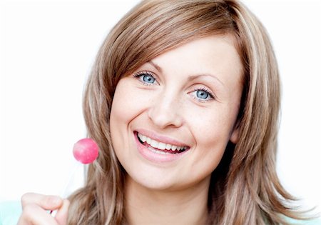 Smiling woman holding a lollipop against a white background Stock Photo - Budget Royalty-Free & Subscription, Code: 400-04191963