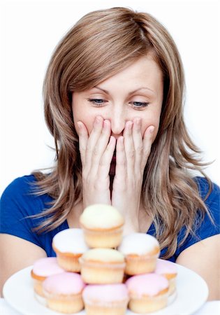 simsearch:400-04212407,k - Joyful woman eating a cake against a white background Stock Photo - Budget Royalty-Free & Subscription, Code: 400-04191974