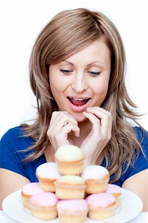 simsearch:400-04212407,k - Impatient woman eating a cake against a white background Stock Photo - Budget Royalty-Free & Subscription, Code: 400-04191973