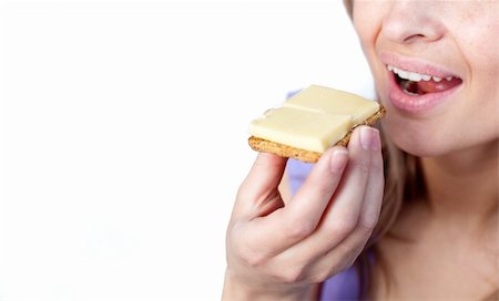 simsearch:400-04212407,k - Close-up of a woman eating a cracker with cheese isolated on a white background Stock Photo - Budget Royalty-Free & Subscription, Code: 400-04192003