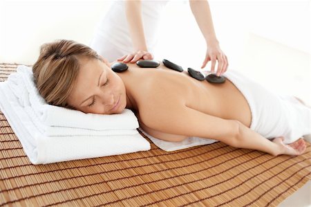 simsearch:400-04192063,k - Delighted woman lying on a massage table having a stone therapy Fotografie stock - Microstock e Abbonamento, Codice: 400-04192067