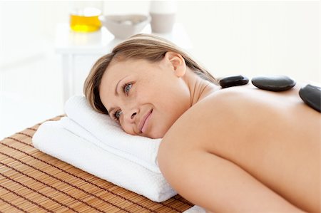 simsearch:400-04192063,k - Cute woman relaxing on a massage table against a white background Fotografie stock - Microstock e Abbonamento, Codice: 400-04192083