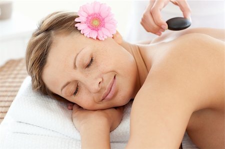 simsearch:400-04192103,k - Portrait of a radiant woman having a flower on a massage table Stock Photo - Budget Royalty-Free & Subscription, Code: 400-04192098