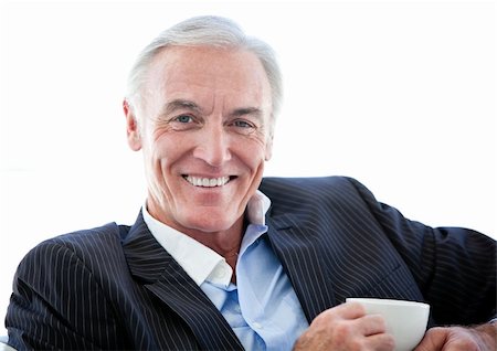 simsearch:400-05242665,k - Happy senior businessman drinking a coffee against a white background Foto de stock - Super Valor sin royalties y Suscripción, Código: 400-04192166