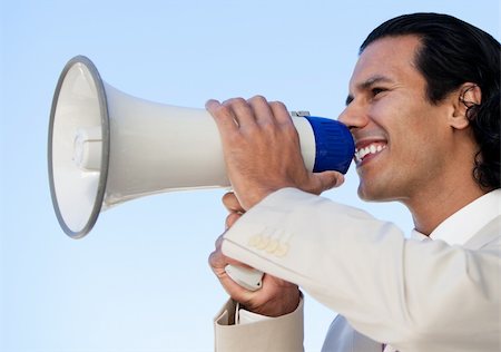 simsearch:400-04126489,k - Portrait of an hispanic business man shouting through a megaphone against a blue sky background Stock Photo - Budget Royalty-Free & Subscription, Code: 400-04192247