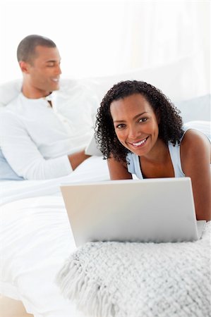 Smiling couple relaxing on their bed at home Stock Photo - Budget Royalty-Free & Subscription, Code: 400-04192373