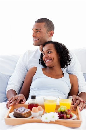 simsearch:693-08127560,k - Enamoured Afro-american couple having breakfast lying on their bed Stock Photo - Budget Royalty-Free & Subscription, Code: 400-04192402