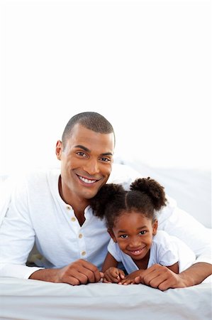 Affectionate father and his daughter having fun lying on a bed Stock Photo - Budget Royalty-Free & Subscription, Code: 400-04192444