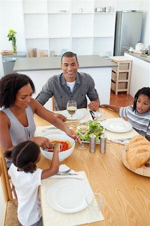 family around a table eating pasta - Ethnic family dining together in the kitchen Stock Photo - Budget Royalty-Free & Subscription, Code: 400-04192450