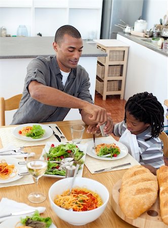 Caring father helping his son cut vegetables in the kitchen Stock Photo - Budget Royalty-Free & Subscription, Code: 400-04192460